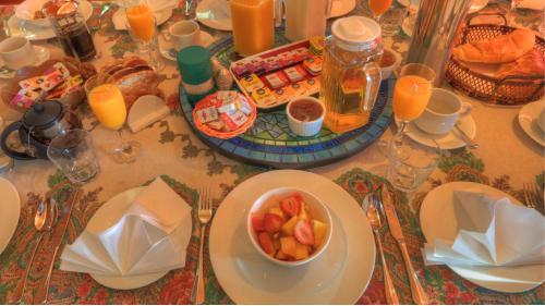 a table with plates of food and a bowl of fruit at Maleny Tropical Retreat in Maleny