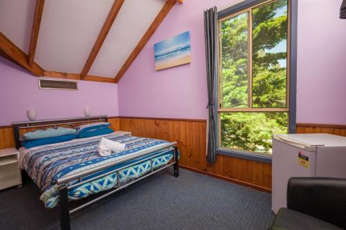 A bed or beds in a room at Dunsborough Beachouse YHA