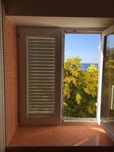 a window in a room with a view at Guesthouse Punta Mira - Beachfront in Novalja