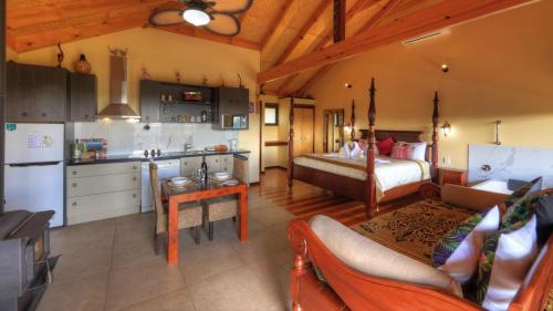 a living room with a kitchen and a bedroom at Maleny Tropical Retreat in Maleny