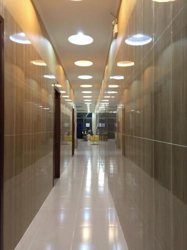 an empty hallway in a building with lights on the ceilings at Hotel Lê My in Can Tho
