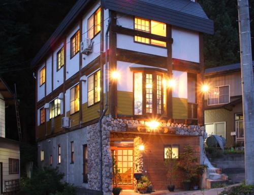 a house at night with its lights on at Koguma no ie in Nozawa Onsen