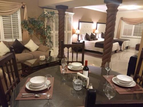 1 dormitorio y sala de estar con mesa de comedor. en Confortable y acogedor Departamento por UACH II, en Chihuahua