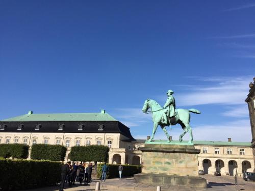 a statue of a man riding a horse in front of a building at Camillas Holiday home Copenhagen City Centre in Copenhagen