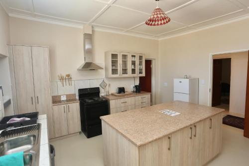 a kitchen with a island in the middle of it at Aloe Rock House in Aus