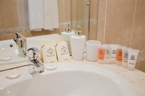 a bathroom sink with toiletries on a counter at Platinum Hotel & Casino in Sunny Beach