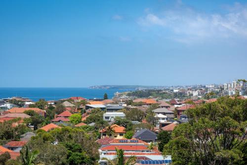 a city with houses and the ocean in the background at Stunning Views To Beat Lockdown Blues in Sydney