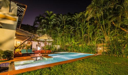 a swimming pool in the yard of a house at Lemon Tree Amarante Beach Resort, Goa in Candolim