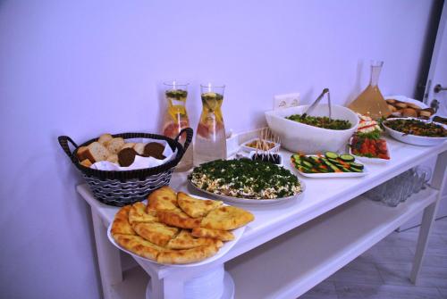 a table topped with plates of food and bowls of food at Hotel Casa calda in Kutaisi