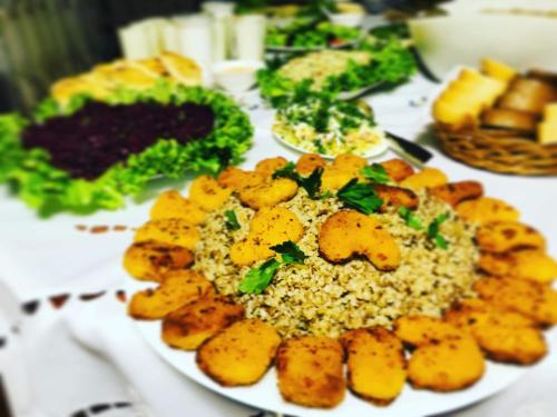 a plate of food with rice and vegetables on a table at Hotel Casa calda in Kutaisi