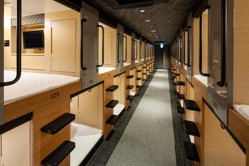 an empty hallway in a train car at Y's CABIN&HOTEL Naha Kokusai Street in Naha