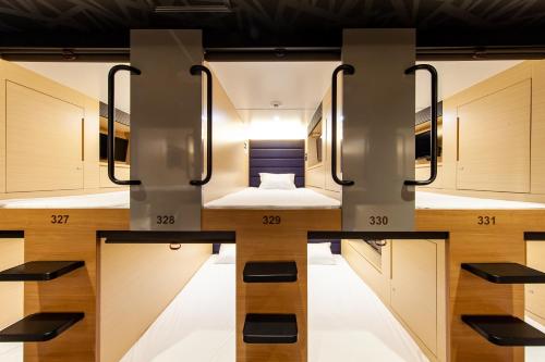 a hotel room with a bed in the middle at Y's CABIN&HOTEL Naha Kokusai Street in Naha