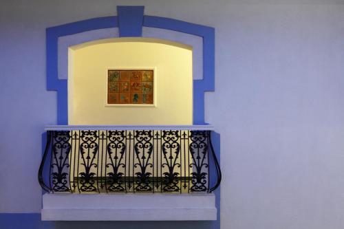a balcony with a painting on a blue wall at Lemon Tree Amarante Beach Resort, Goa in Candolim