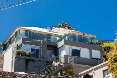 a white building with plants on the top of it at Stunning Views To Beat Lockdown Blues in Sydney