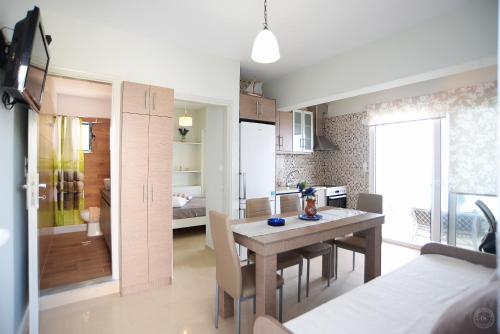 a kitchen and dining room with a table and chairs at MOUSELIS APARTMENTS in Kalymnos