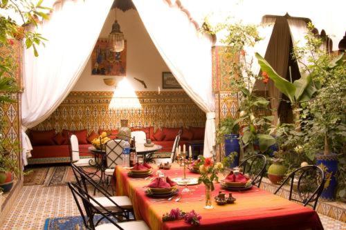 a dining room with a table and chairs in a building at Riad Maryam Taroudant in Taroudant