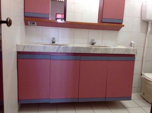 La salle de bains colorée est pourvue de 2 lavabos et de toilettes. dans l'établissement Casa Verde Albuquerque, à Fortaleza