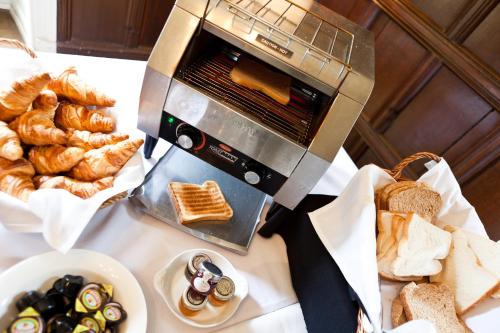 a toaster oven sitting on top of a table with bread at Best Western Plus Sheffield Mosborough Hall Hotel in Sheffield
