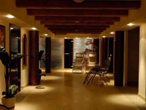 a hallway with chairs and a painting on the wall at Hotel Lubicz in Ustka