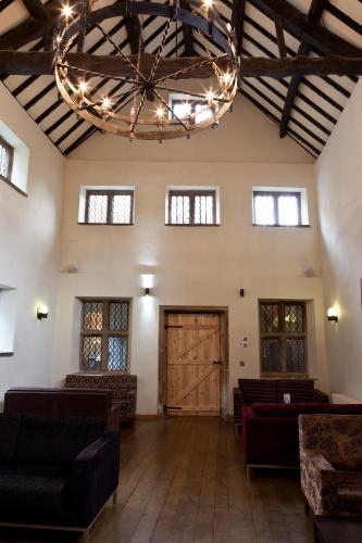 a large room with couches and a large chandelier at Best Western Plus Sheffield Mosborough Hall Hotel in Sheffield