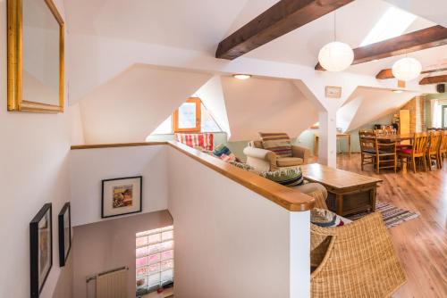 a living room with a staircase and a dining room at Chalet GoSlo in Srpenica