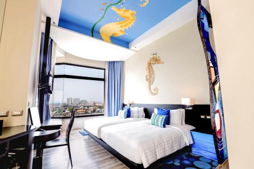 a bedroom with a bed with a seahorse mural on the ceiling at Siam@Siam Design Hotel Pattaya in Pattaya