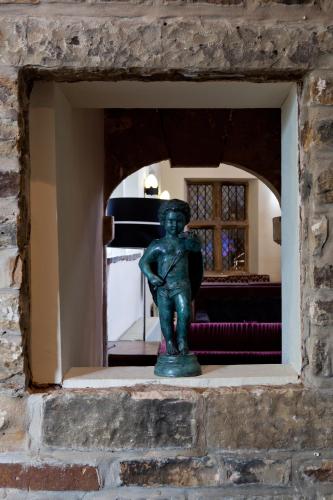 a statue of a woman sitting in a room at Best Western Plus Sheffield Mosborough Hall Hotel in Sheffield