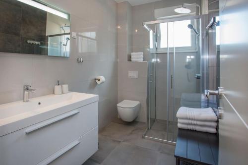 a bathroom with a shower and a sink and a toilet at Luxury apartment Marjan - Black in Split