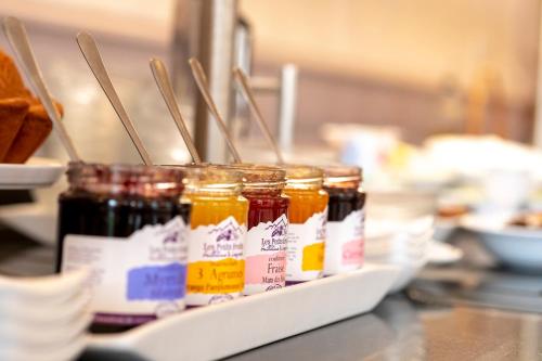 a row of jars of jam on a counter at Grand Hotel Gallia & Londres in Lourdes