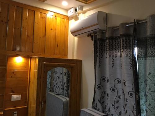 a room with a shower and a door with a curtain at Blue Lagoon Khavane, Tarkarli- Malvan in Vengurla