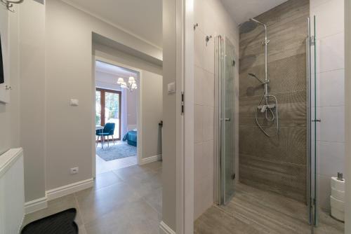 a bathroom with a walk in shower and a glass shower stall at Biały Zakątek in Szklarska Poręba