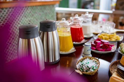 a table with two bottles of juice and fruit at Bai Dinh Garden Resort & Spa in Ninh Binh
