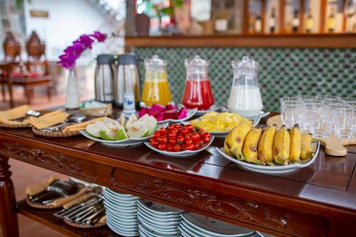 a table with plates of food on top at Bai Dinh Garden Resort & Spa in Ninh Binh