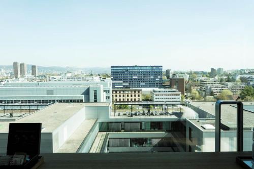 an office building with a view of a city at Placid Hotel Design & Lifestyle Zurich in Zürich