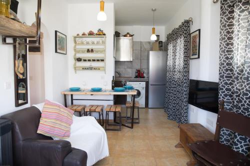 a living room with a couch and a kitchen at MP Cozy Apartment Near the Sea in Paphos City