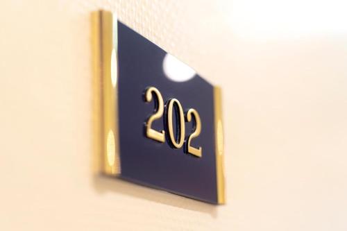 a sign on a wall with the number on it at Dünenhotel am Meer in Warnemünde