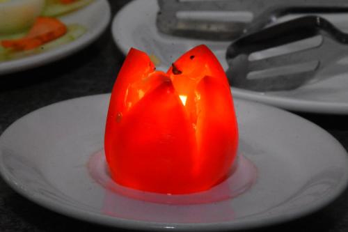 a red object on a white plate on a table at HOTEL KEK GRAND PARK in Chennai