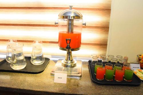 a blender sitting on a counter with a group of glasses at HOTEL KEK GRAND PARK in Chennai