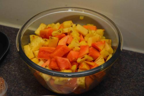 a bowl filled with chopped fruits and vegetables on a counter at HOTEL KEK GRAND PARK in Chennai