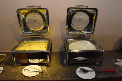 three trays of food sitting on top of a counter at HOTEL KEK GRAND PARK in Chennai