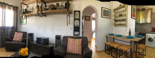 a living room with a table and some chairs at MP Cozy Apartment Near the Sea in Paphos City