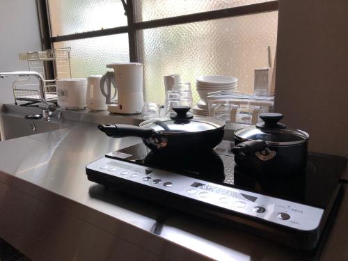 Kuhinja ili čajna kuhinja u objektu Santiago Guesthouse Naha