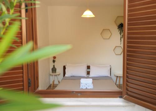 a bedroom with a bed with two white pillows at Villa Maraki in Agia Paraskevi