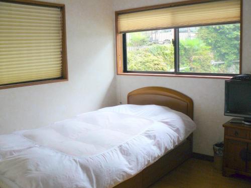 Voodi või voodid majutusasutuse Ryokan Yamashiroya toas
