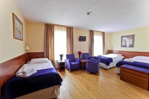 Ένα ή περισσότερα κρεβάτια σε δωμάτιο στο Apartamenty Pod Lwem