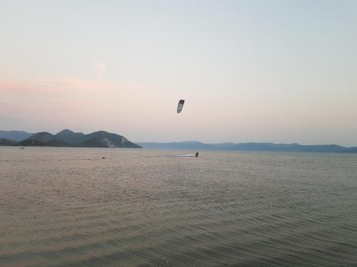 a person flying a kite in the middle of the water at Stara kuća Estate in Ljubuški