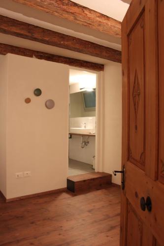 an open door to a room with a kitchen at The Court House in Bressanone