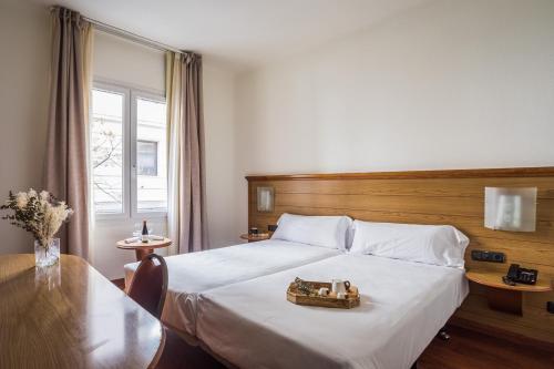 a hotel room with a bed with a tray on it at Negresco Gran Via in Madrid