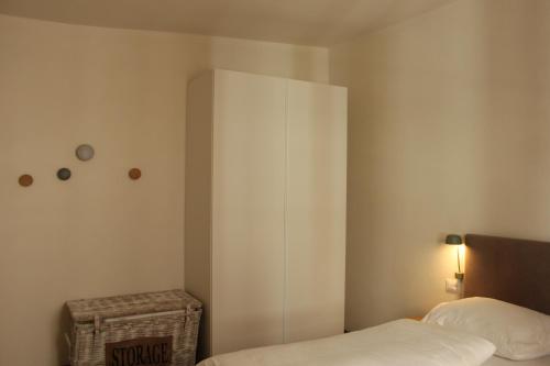 a bedroom with a bed and a white cabinet at The Court House in Bressanone
