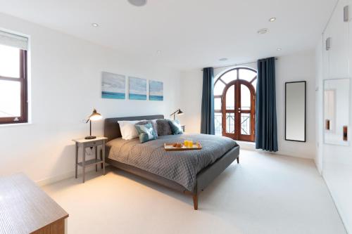 a bedroom with a bed with a tray on it at Hampden Apartments - The Henry in Windsor